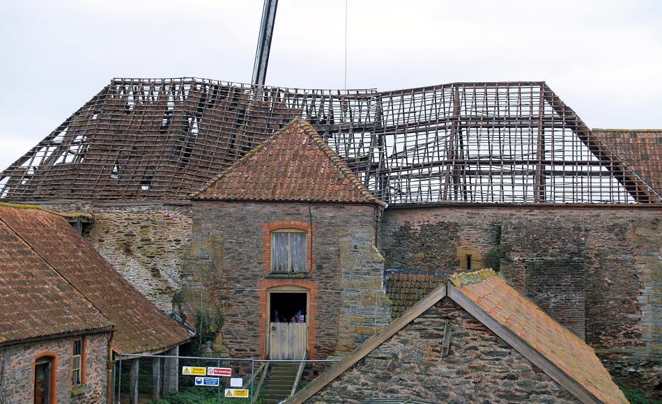 During award winning grant repairs - Roof repairs to large Somerset Tithe barn with craned sections of repaired historic structure repositioned.