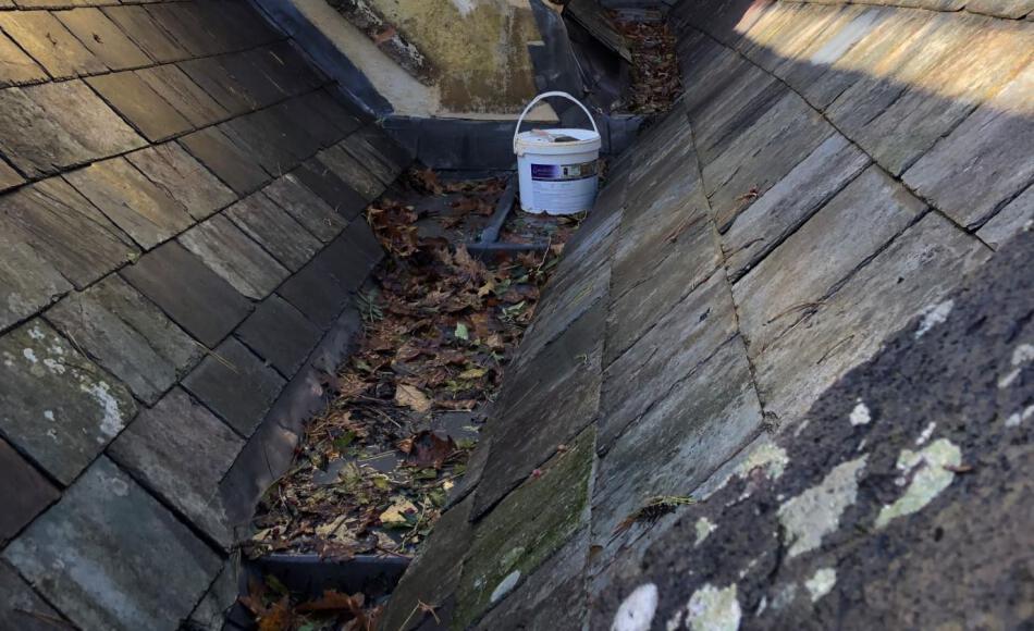 Newly built leaded valley gutter already filled with leaves in less than two months