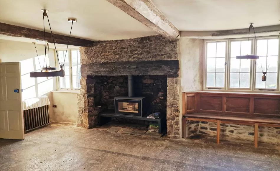 Limeash floors, and rubblestone fireplace, with cast iron radiators and energy efficient wood burner