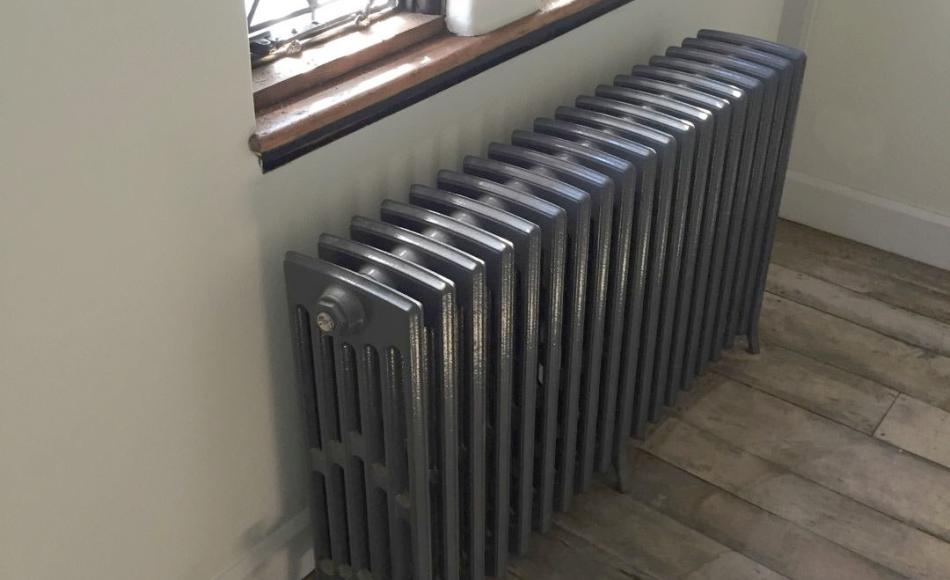 New cast iron column radiator and overhauled leaded lights.