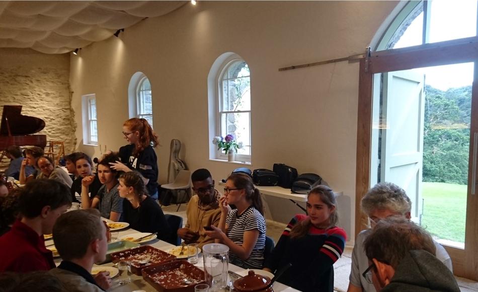 Music course attendees enjoying lunch in the converted performance space.