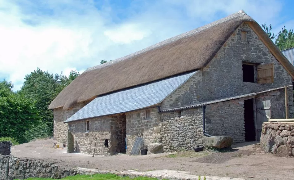 After repairs - Dartmoor threshing barn re-thatched and slated, masonry and joinery repairs.
