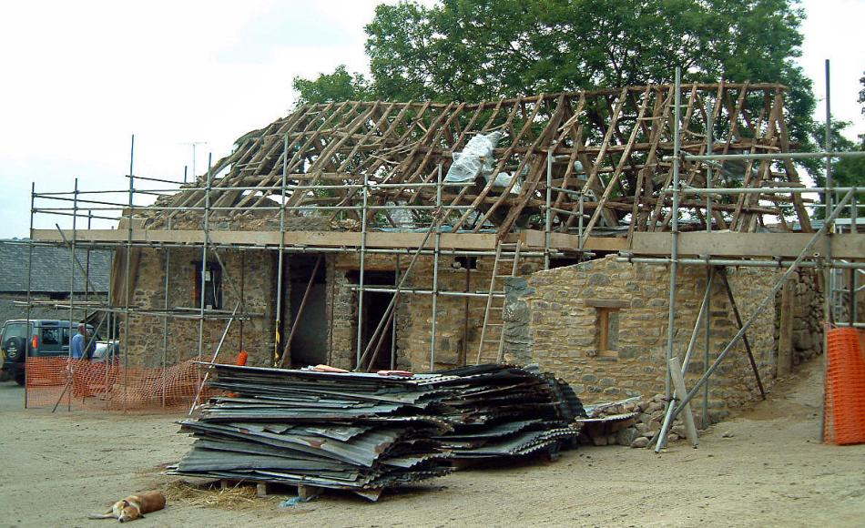 Exmoor barn - modern corrugated metal sheet removed before new over-roof structure and re-slating