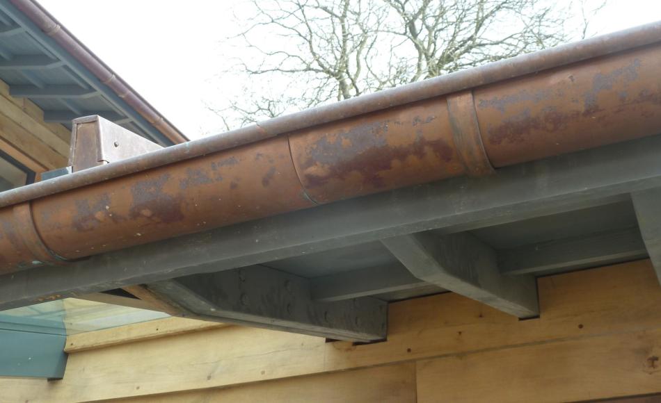 Copper gutter beginning to oxidise, patinate and visually soften 