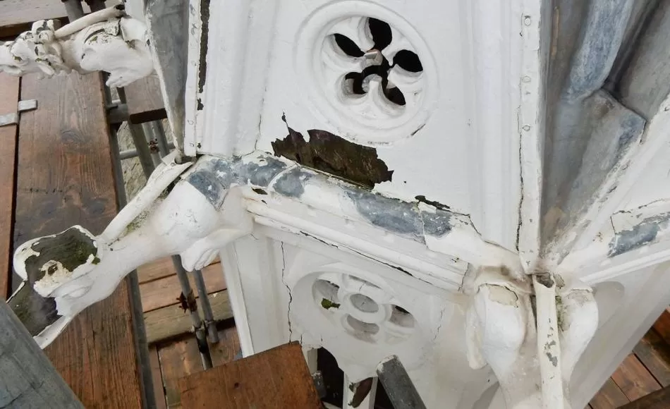 Before repair: failing paint finish, extensive timber decay and poorly detailed rainwater discharge. 