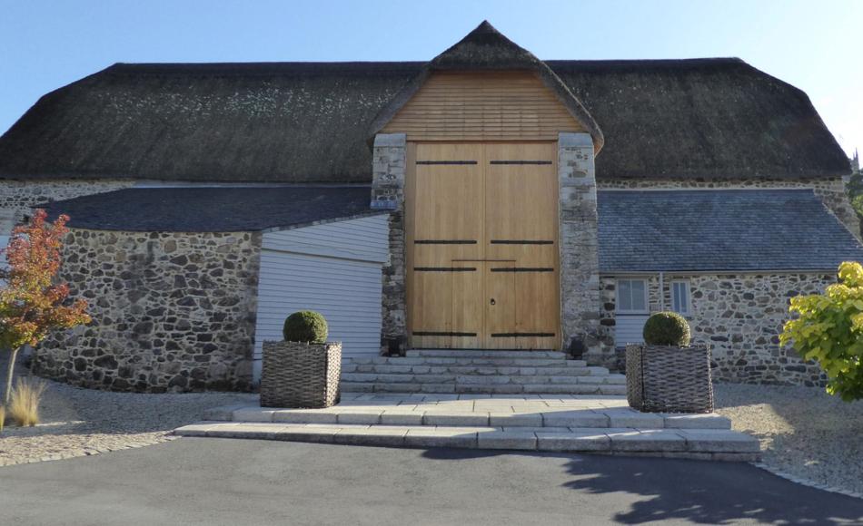 Courtyard elevation of the converted 16th century Great Barn, Higher Ashton 