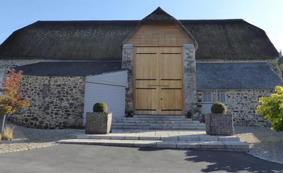 Courtyard elevation of the converted 16th century Great Barn, Higher Ashton 