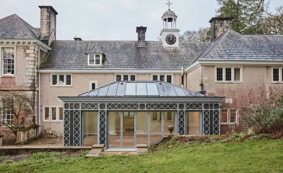 The lead covered orangery with external galvanised trellis work is visually distinct from the solid masonry masses of the main building