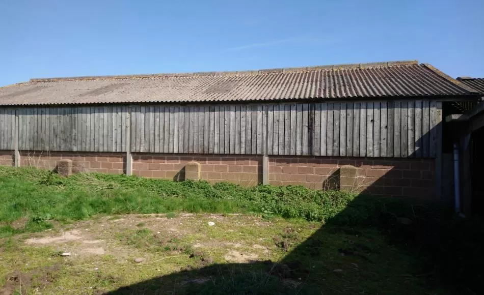 One of the modern barns to be replaced with sympathetically designed new houses