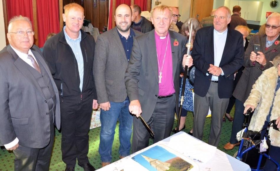 Director Julian Clayton and George Hael of Wells Cathedral Stonemasons were invited to the service. Pictured here with the Rt Rev Peter Hancock and some of the many parishioners who attended the service 