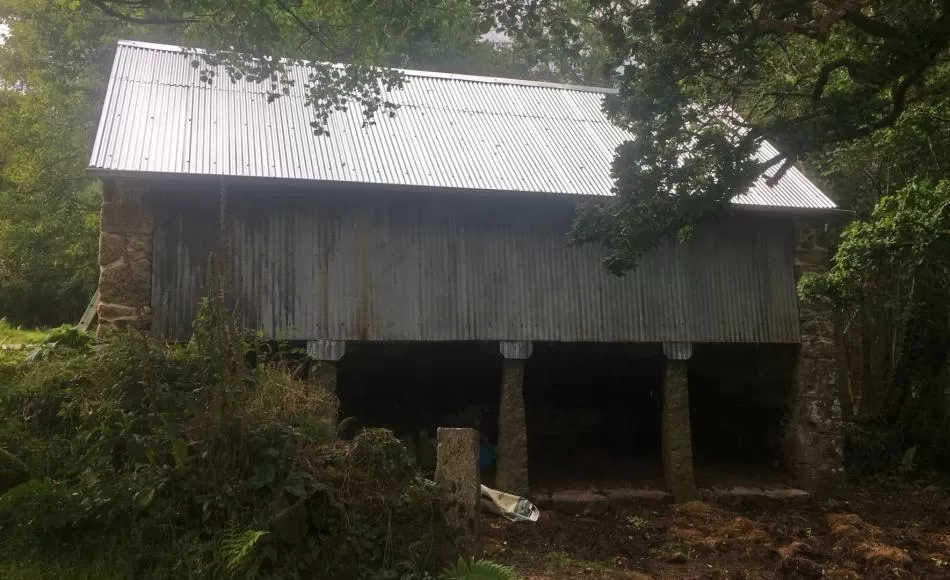 After: renewed roof sheeting above retained sound vertical cladding