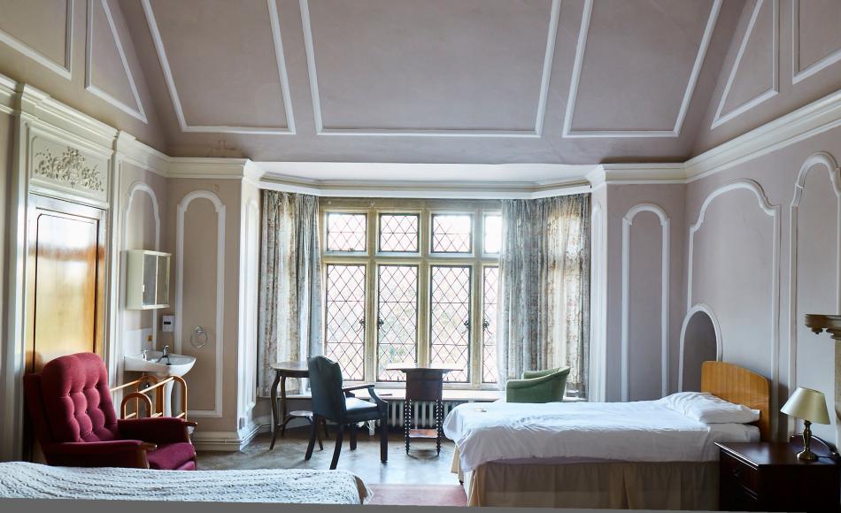 One of the historic bedrooms. Halsway Manor and its mews house can sleep up to 65 people. 