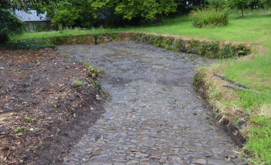 The large stones which form the base of the pond are embedded in clay