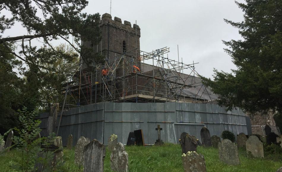 Scaffolding to tower going up with protections at base and no fixings into existing fabric.