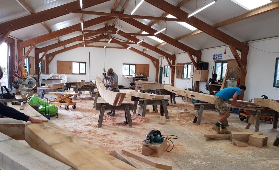 Oak frames being finished in the Carpenter Oak Workshop  