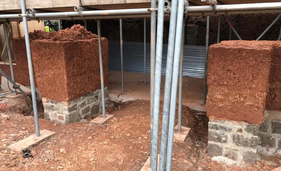 Threshing barn doors being rebuilt on masonry plinths