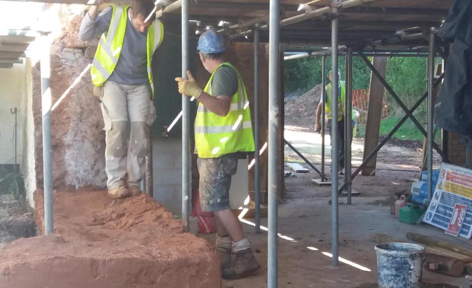 Treading down the first lift to compact the cob