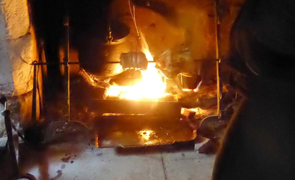 The fireplace as a cooking space with copper boiler, pipkin and spit for roasting