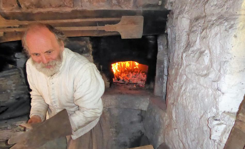 Stuart Peachey demonstrating the firing of a traditional oven 