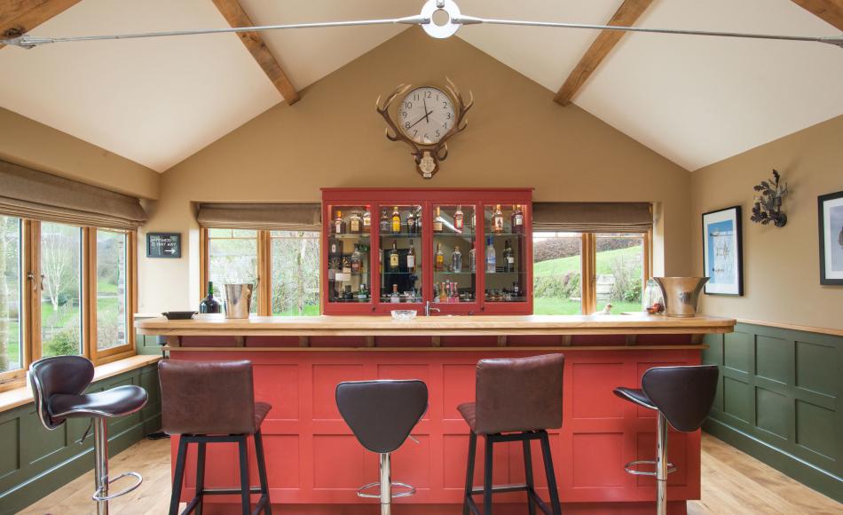 The games room extension has lofty ceilings and exposed trusses which reflect the heritage of the main house