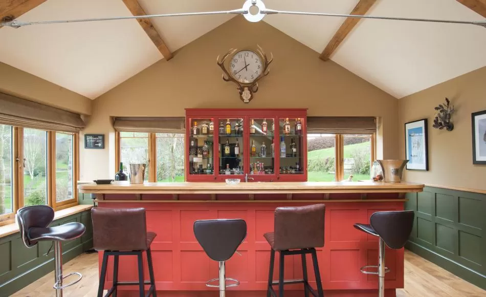 The games room extension has lofty ceilings and exposed trusses which reflect the heritage of the main house